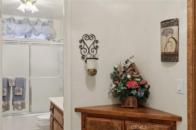 24571 Albrun Dr, Crestline, CA 92325 - bathroom with toilet, shower / bath combination with glass door, and vanity