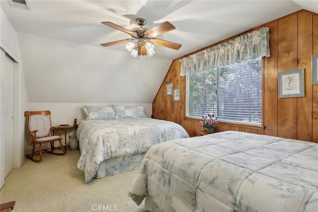 24571 Albrun Dr, Crestline, CA 92325 - carpeted bedroom featuring lofted ceiling, wooden walls, ceiling fan, and a closet
