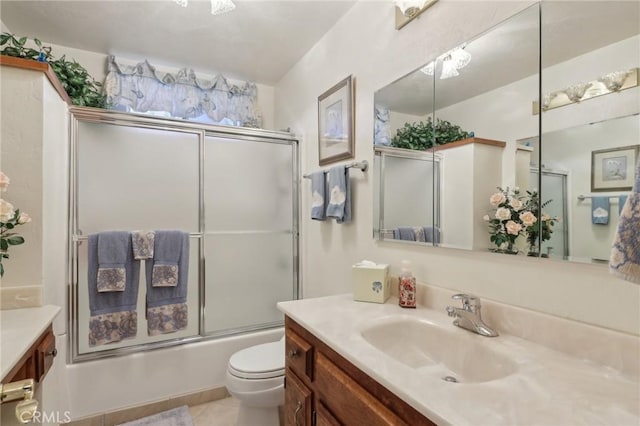 24571 Albrun Dr, Crestline, CA 92325 - full bathroom with vanity, toilet, tile patterned flooring, and shower / bath combination with glass door