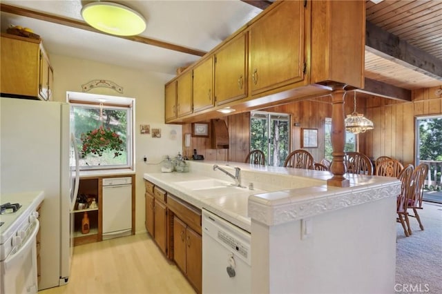 24571 Albrun Dr, Crestline, CA 92325 - kitchen with white appliances, a sink, a peninsula, brown cabinets, and wooden walls