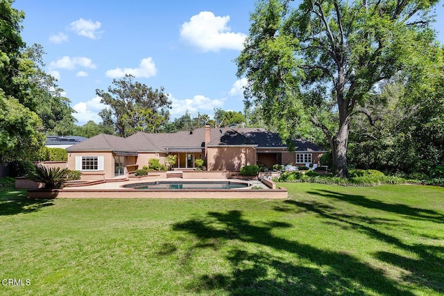525 Laguna Rd, Pasadena, CA 91105 - rear view of house with a yard, an outdoor pool, a chimney, and stucco siding