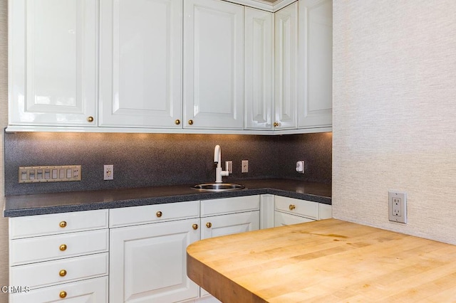 525 Laguna Rd, Pasadena, CA 91105 - kitchen with a sink, white cabinets, wooden counters, and backsplash