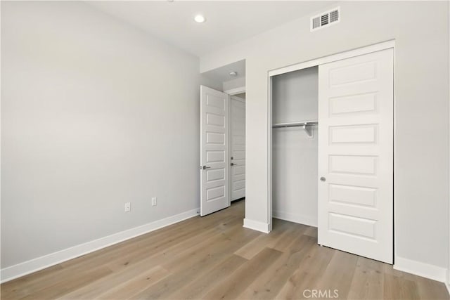 208 Stage, Irvine, CA 92618 - unfurnished bedroom featuring recessed lighting, light wood-style floors, and a closet