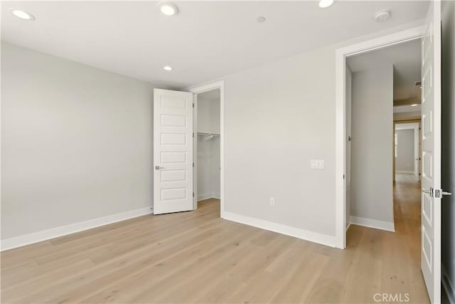 208 Stage, Irvine, CA 92618 - unfurnished bedroom with recessed lighting, light wood-type flooring, a closet, and a spacious closet