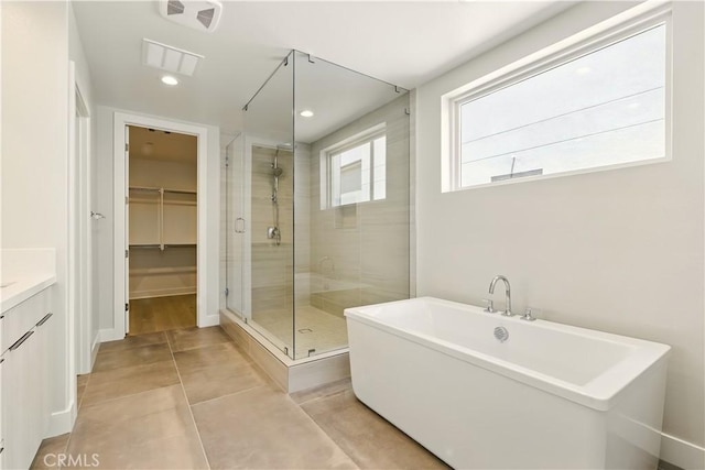 208 Stage, Irvine, CA 92618 - bathroom featuring a stall shower, a freestanding bath, a spacious closet, vanity, and recessed lighting
