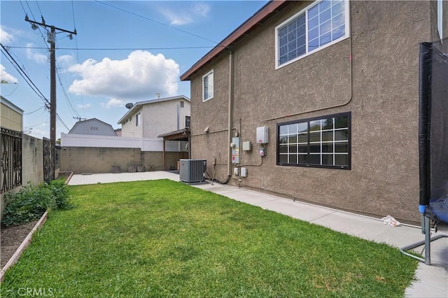 rear view of house featuring cooling unit, stucco siding, and a patio