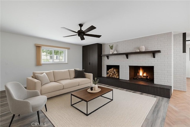 living room with ceiling fan, a fireplace, and baseboards