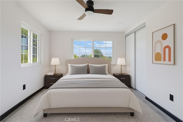 bedroom with a closet, baseboards, and a ceiling fan