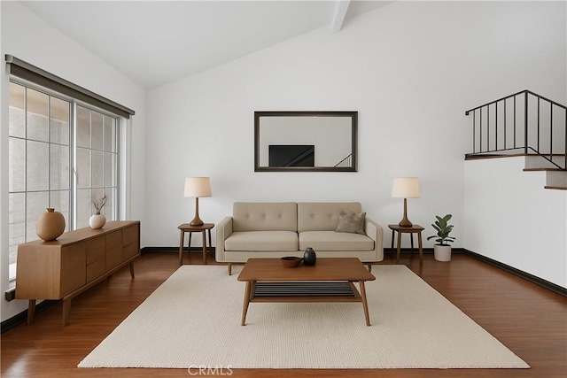 living area with lofted ceiling, wood finished floors, and baseboards