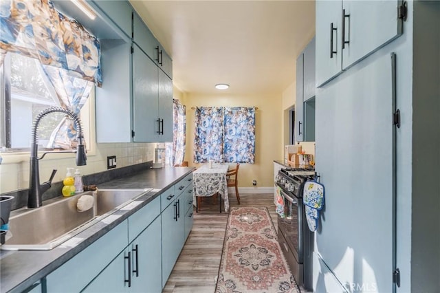 1763 W 245th St, Torrance, CA 90501 - kitchen with range with gas stovetop, a sink, light wood finished floors, backsplash, and baseboards