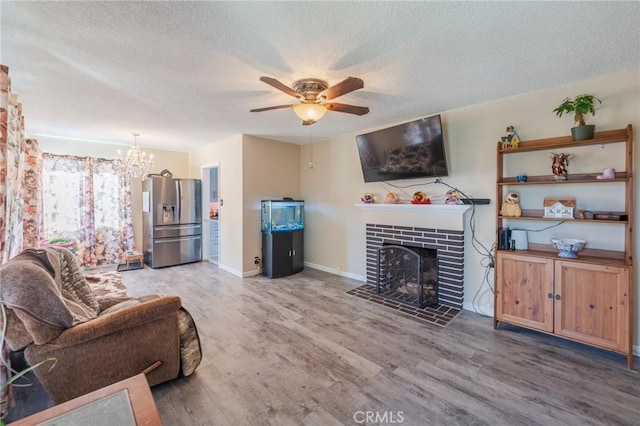 1763 W 245th St, Torrance, CA 90501 - living area with a textured ceiling, wood finished floors, a ceiling fan, a fireplace, and a chandelier