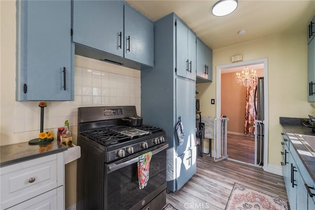 1763 W 245th St, Torrance, CA 90501 - kitchen featuring gas range oven, dark countertops, a chandelier, and light wood-style flooring