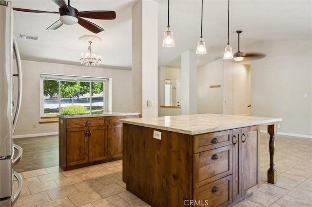 8825 Old Santa Rosa Rd, Atascadero, CA 93422 - kitchen with lofted ceiling, a kitchen island, freestanding refrigerator, ceiling fan, and pendant lighting