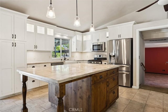 8825 Old Santa Rosa Rd, Atascadero, CA 93422 - kitchen featuring appliances with stainless steel finishes, a sink, light tile patterned flooring, white cabinets, and lofted ceiling