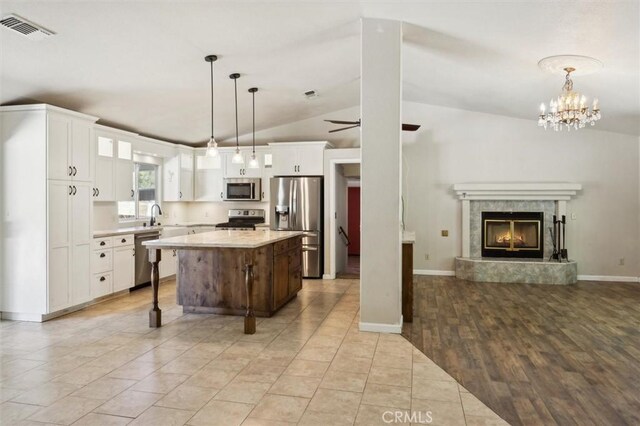 8825 Old Santa Rosa Rd, Atascadero, CA 93422 - kitchen featuring appliances with stainless steel finishes, open floor plan, light countertops, lofted ceiling, and white cabinetry