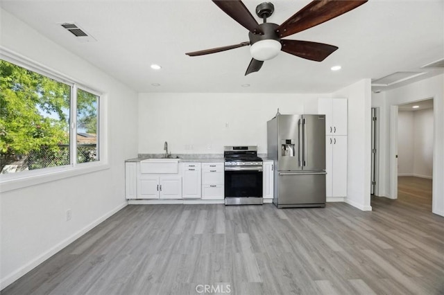 8825 Old Santa Rosa Rd, Atascadero, CA 93422 - kitchen featuring stainless steel appliances, a sink, light countertops, light wood finished floors, and recessed lighting