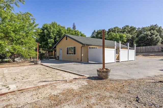 8825 Old Santa Rosa Rd, Atascadero, CA 93422 - view of front of property with a patio area, stucco siding, and view of wooded area