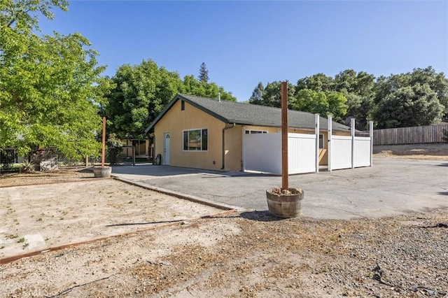 8825 Old Santa Rosa Rd, Atascadero, CA 93422 - view of front of house with a patio area, stucco siding, and view of wooded area