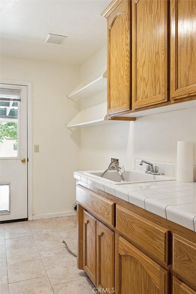 8825 Old Santa Rosa Rd, Atascadero, CA 93422 - kitchen with open shelves, a sink, tile countertops, light tile patterned floors, and baseboards