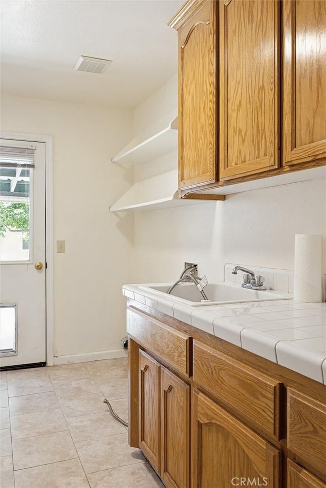 8825 Old Santa Rosa Rd, Atascadero, CA 93422 - kitchen featuring open shelves, tile countertops, and light tile patterned floors