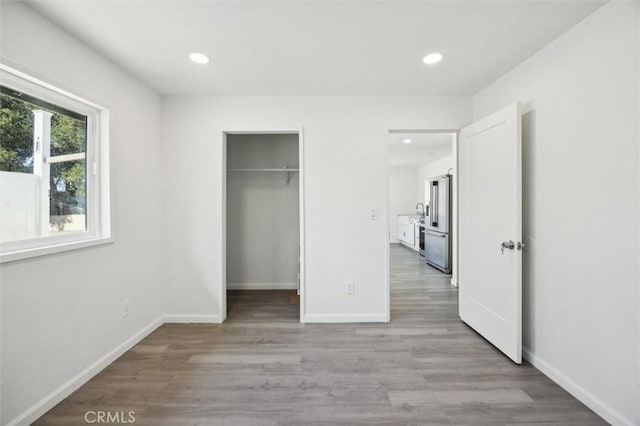 8825 Old Santa Rosa Rd, Atascadero, CA 93422 - unfurnished bedroom featuring recessed lighting, light wood-style flooring, baseboards, high end fridge, and a spacious closet