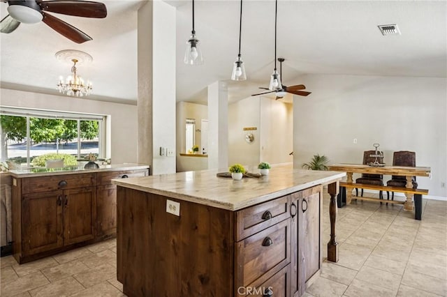 8825 Old Santa Rosa Rd, Atascadero, CA 93422 - kitchen with ceiling fan, vaulted ceiling, a kitchen island, pendant lighting, and a chandelier