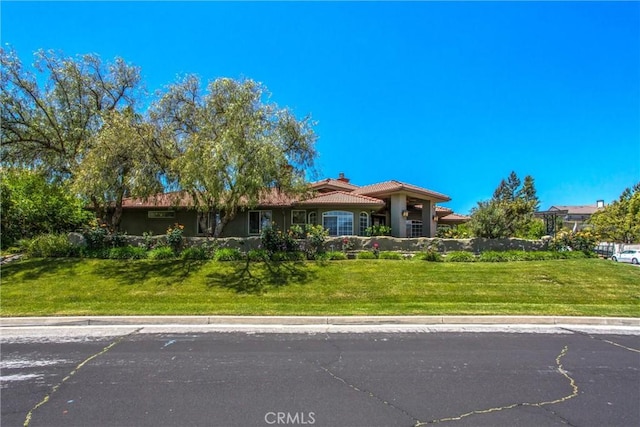 34879 Olive Tree Ln, Yucaipa, CA 92399 - view of front of house with a chimney, a tile roof, and a front lawn