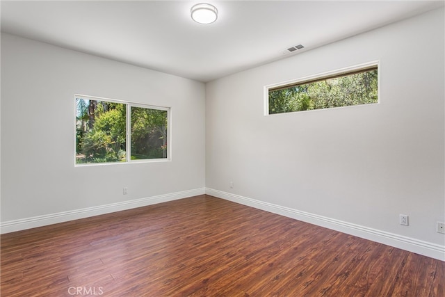 34879 Olive Tree Ln, Yucaipa, CA 92399 - empty room featuring plenty of natural light, wood finished floors, and baseboards
