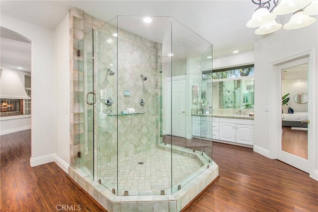 34879 Olive Tree Ln, Yucaipa, CA 92399 - full bath with vanity, wood finished floors, a shower stall, connected bathroom, and baseboards