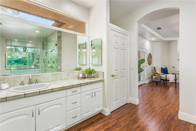 34879 Olive Tree Ln, Yucaipa, CA 92399 - full bathroom with wood finished floors, vanity, a stall shower, and baseboards