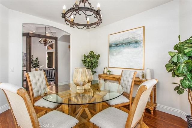 34879 Olive Tree Ln, Yucaipa, CA 92399 - dining space with a chandelier, arched walkways, baseboards, and wood finished floors