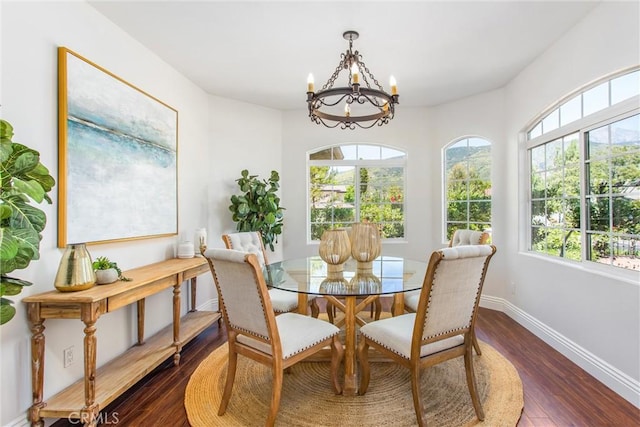 34879 Olive Tree Ln, Yucaipa, CA 92399 - dining space featuring a chandelier, dark wood-style flooring, healthy amount of natural light, and baseboards