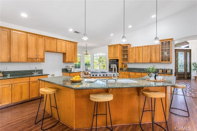 34879 Olive Tree Ln, Yucaipa, CA 92399 - kitchen featuring a sink, oven, brown cabinetry, a spacious island, and recessed lighting