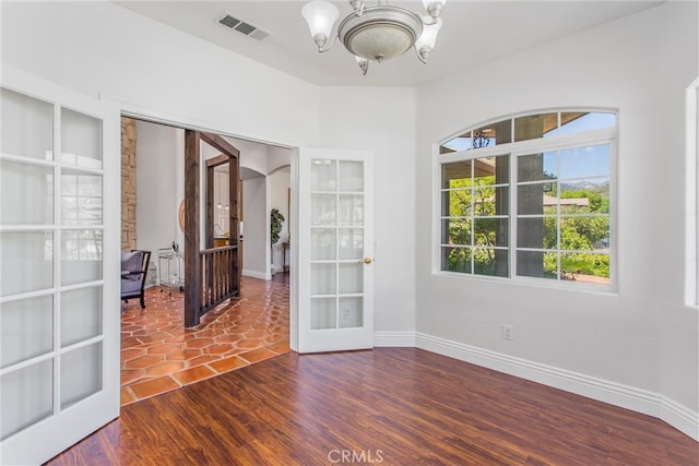 34879 Olive Tree Ln, Yucaipa, CA 92399 - empty room with a chandelier, french doors, baseboards, and wood finished floors