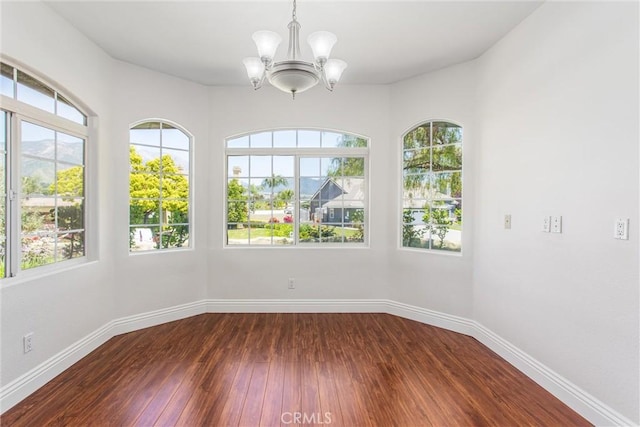 34879 Olive Tree Ln, Yucaipa, CA 92399 - spare room featuring a chandelier, healthy amount of natural light, and baseboards