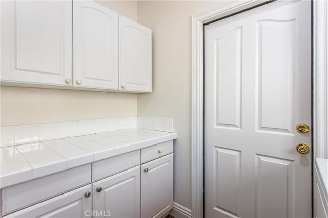 34879 Olive Tree Ln, Yucaipa, CA 92399 - kitchen with white cabinets and tile counters