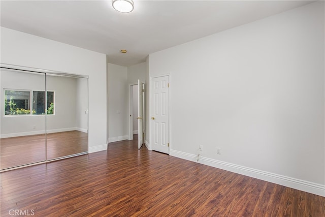 34879 Olive Tree Ln, Yucaipa, CA 92399 - unfurnished bedroom featuring a closet, wood finished floors, and baseboards