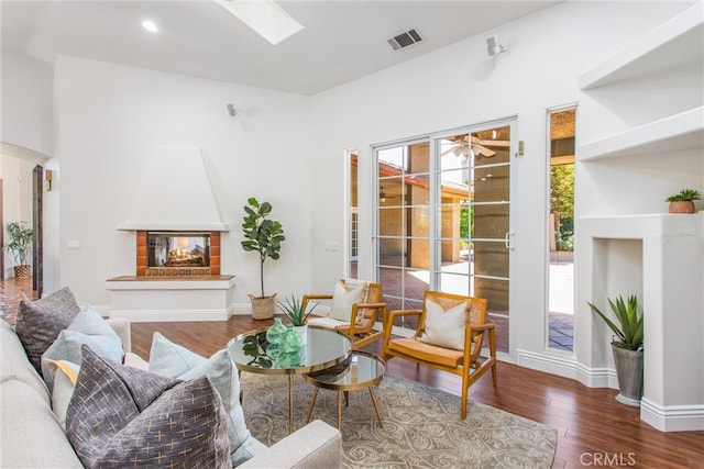 34879 Olive Tree Ln, Yucaipa, CA 92399 - living area with wood finished floors, a skylight, arched walkways, and baseboards