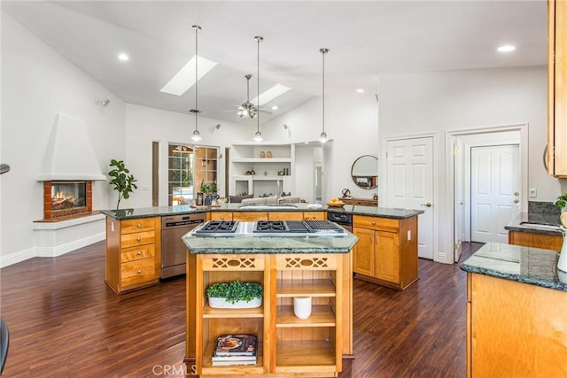 34879 Olive Tree Ln, Yucaipa, CA 92399 - kitchen featuring a spacious island, appliances with stainless steel finishes, dark wood-type flooring, a skylight, and a ceiling fan