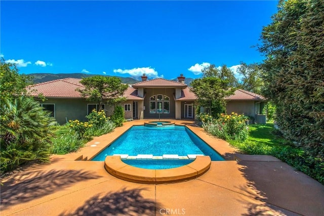34879 Olive Tree Ln, Yucaipa, CA 92399 - view of pool with a pool with connected hot tub, a mountain view, and a patio