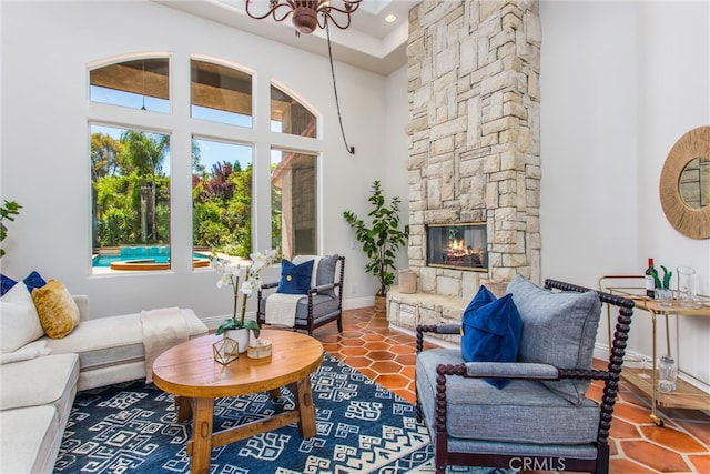 34879 Olive Tree Ln, Yucaipa, CA 92399 - living room with a high ceiling, a chandelier, tile patterned floors, baseboards, and a fireplace