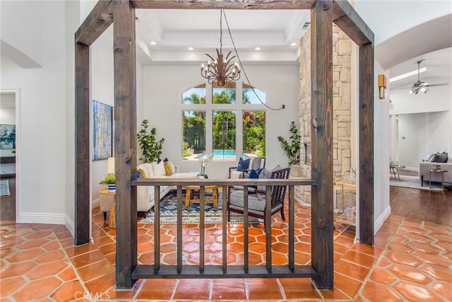 34879 Olive Tree Ln, Yucaipa, CA 92399 - tiled entrance foyer with a chandelier, a high ceiling, baseboards, ornamental molding, and arched walkways