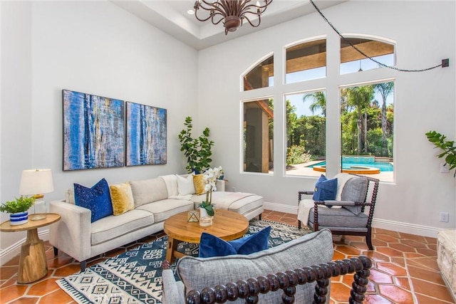 34879 Olive Tree Ln, Yucaipa, CA 92399 - living area featuring a chandelier, baseboards, a towering ceiling, and tile patterned floors