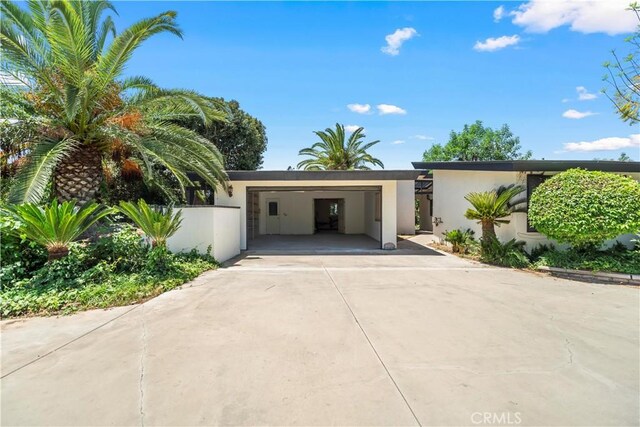 7008 Hawarden Dr, Riverside, CA 92506 - view of front of home featuring driveway, stucco siding, an attached garage, and fence