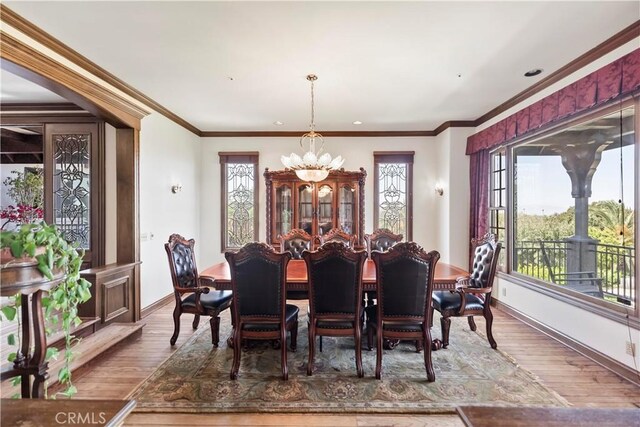 7008 Hawarden Dr, Riverside, CA 92506 - dining area with wood finished floors, baseboards, a chandelier, and ornamental molding