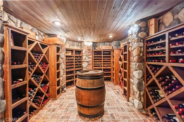 7008 Hawarden Dr, Riverside, CA 92506 - wine area featuring wooden ceiling, brick floors, and recessed lighting