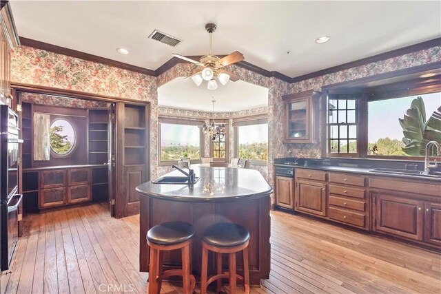 7008 Hawarden Dr, Riverside, CA 92506 - bar with a sink, wallpapered walls, light wood finished floors, crown molding, and a ceiling fan