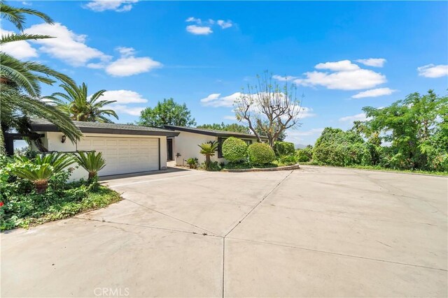 7008 Hawarden Dr, Riverside, CA 92506 - view of front of property with concrete driveway, stucco siding, and an attached garage