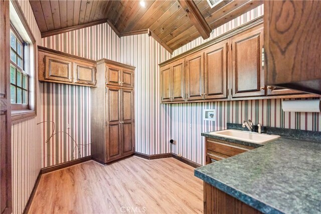 7008 Hawarden Dr, Riverside, CA 92506 - washroom with cabinet space, light wood-type flooring, wooden ceiling, wallpapered walls, and washer hookup