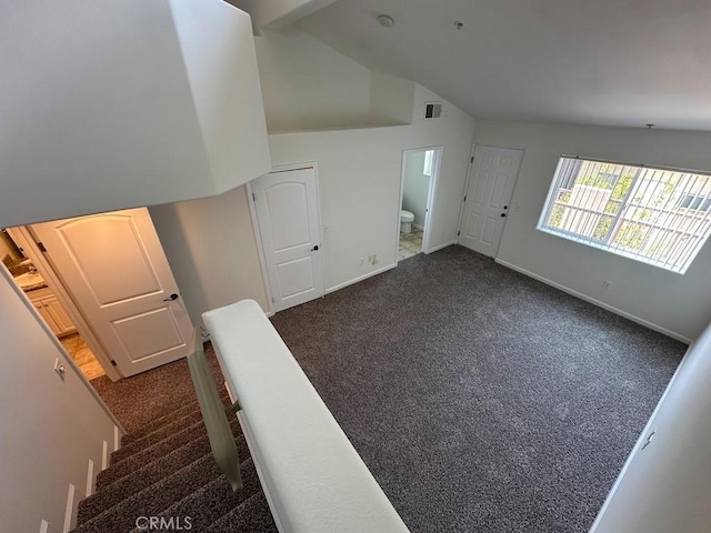 stairway with carpet flooring, lofted ceiling, and baseboards